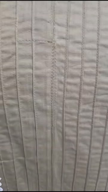 Close-up of hand-finished pintuck cotton fabric texture